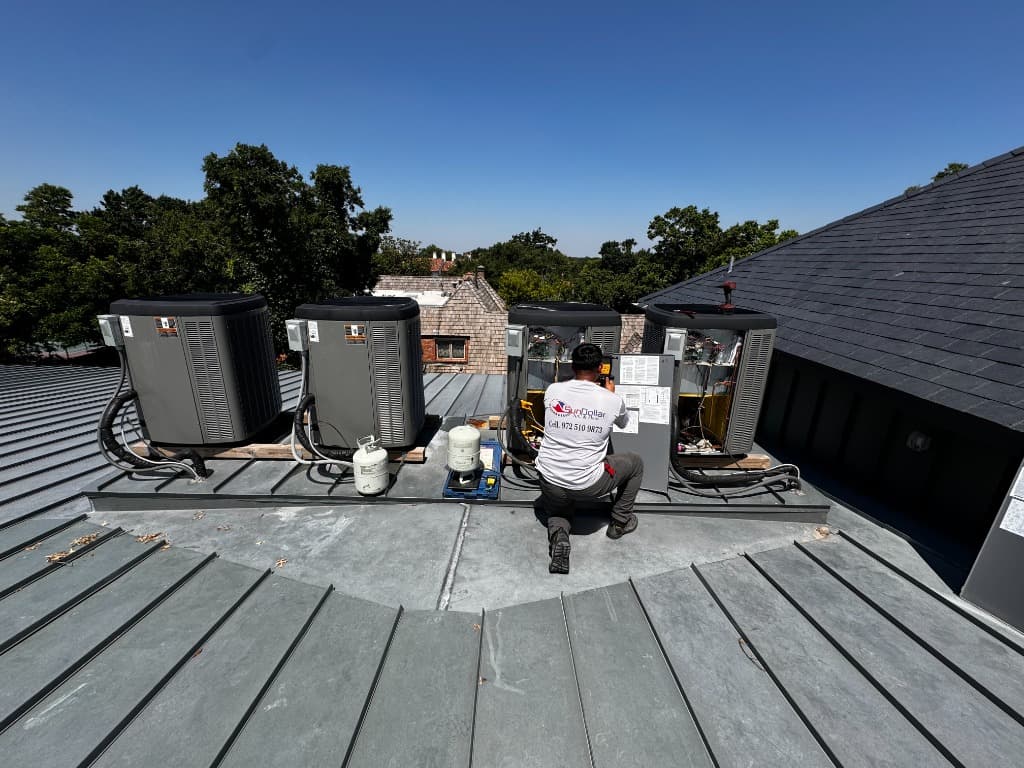 SunDollar technician performing HVAC repairs on rooftop units
